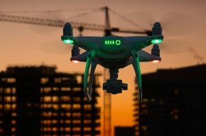 Silhouette of Drone In The Air Over Buildings Under Construction